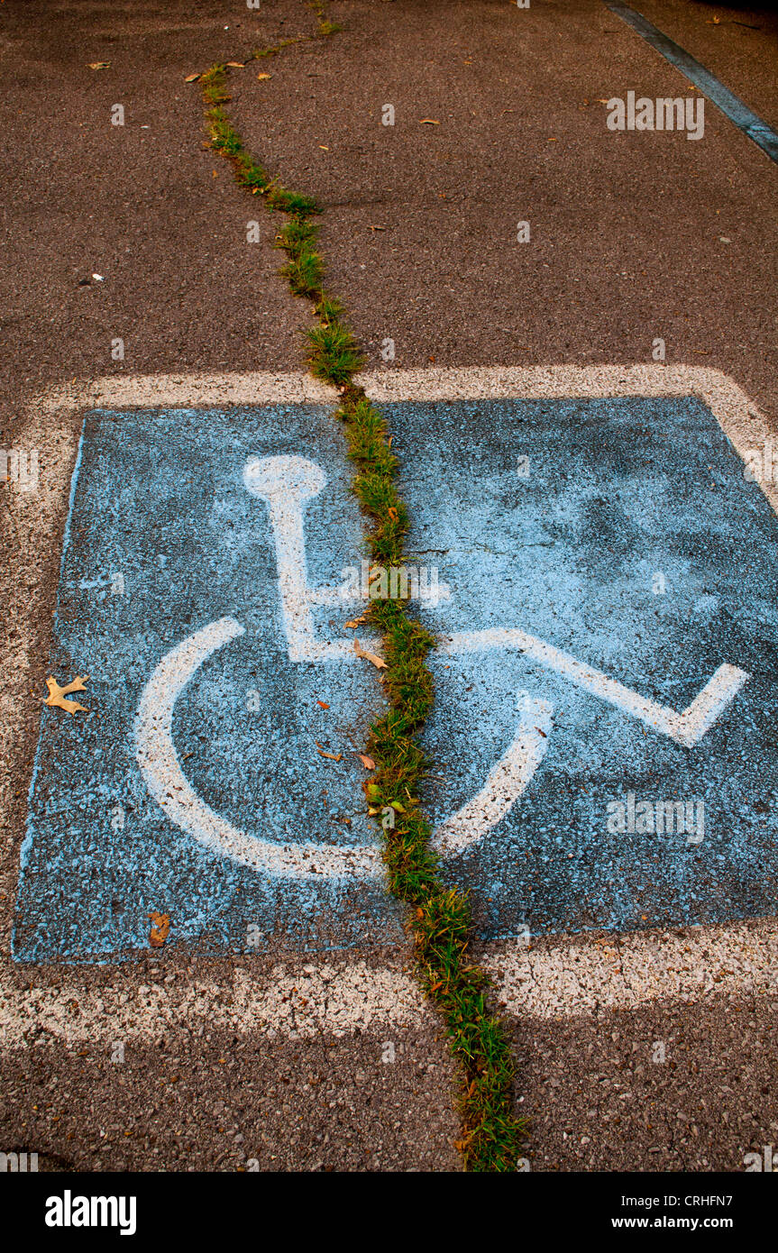 blue painted handicap sign in parking lot or parking space Stock Photo