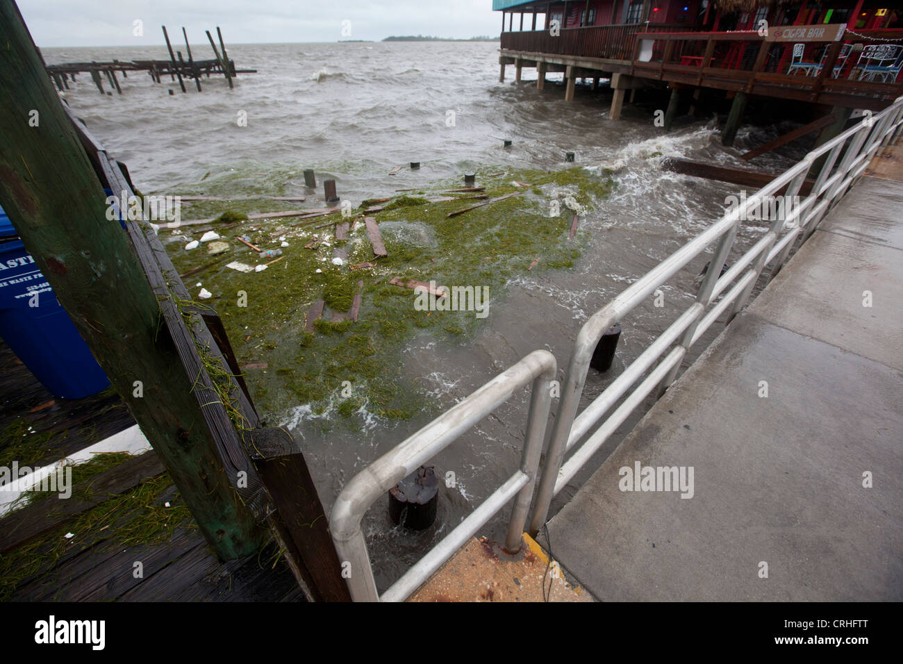 Debris washed up along the seawalls of Dock Street in Cedar Key Florida from Tropical Storm Debby Stock Photo
