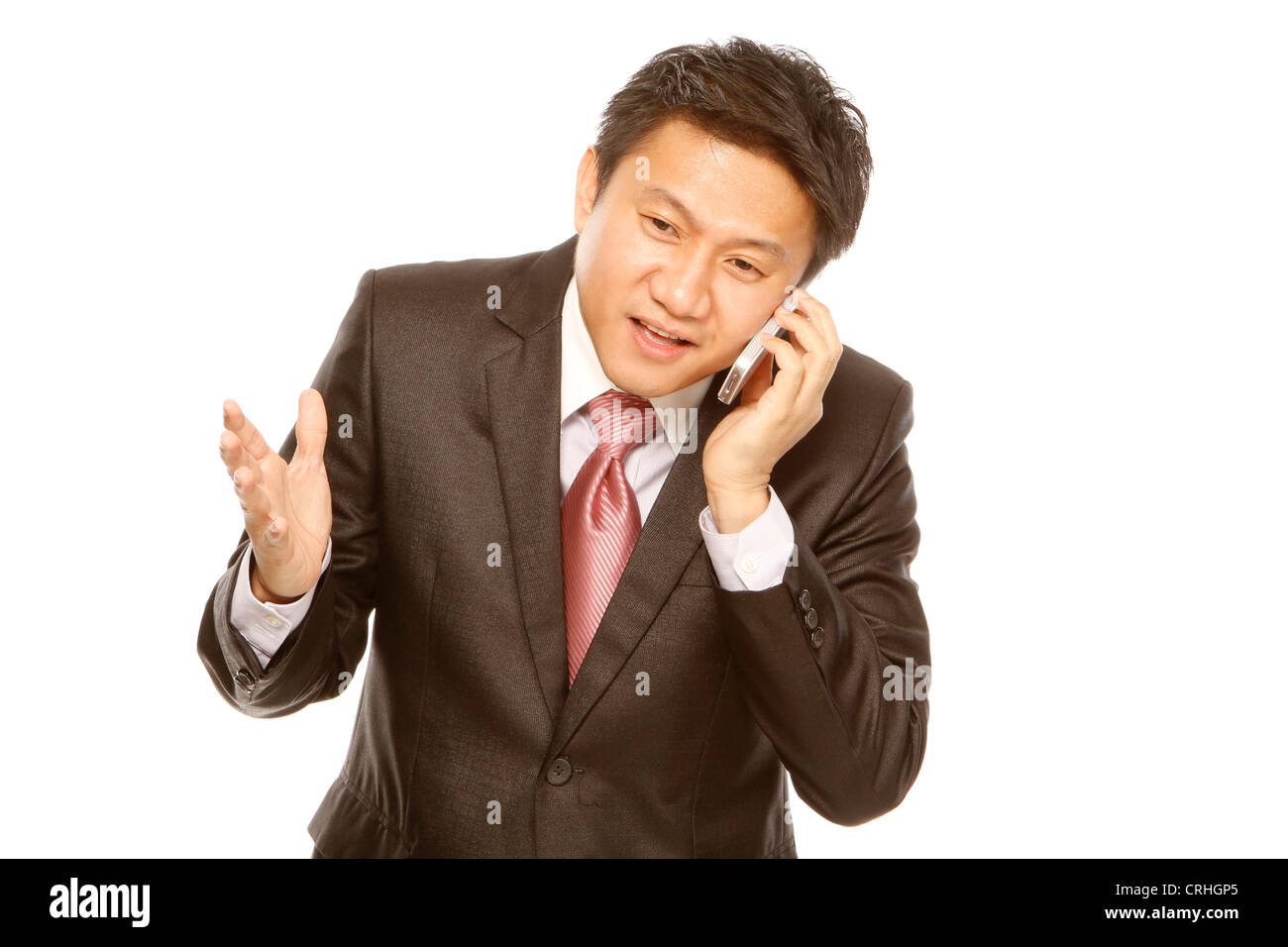 A man in business attire holding a mobile phone (isolated on white) Stock Photo