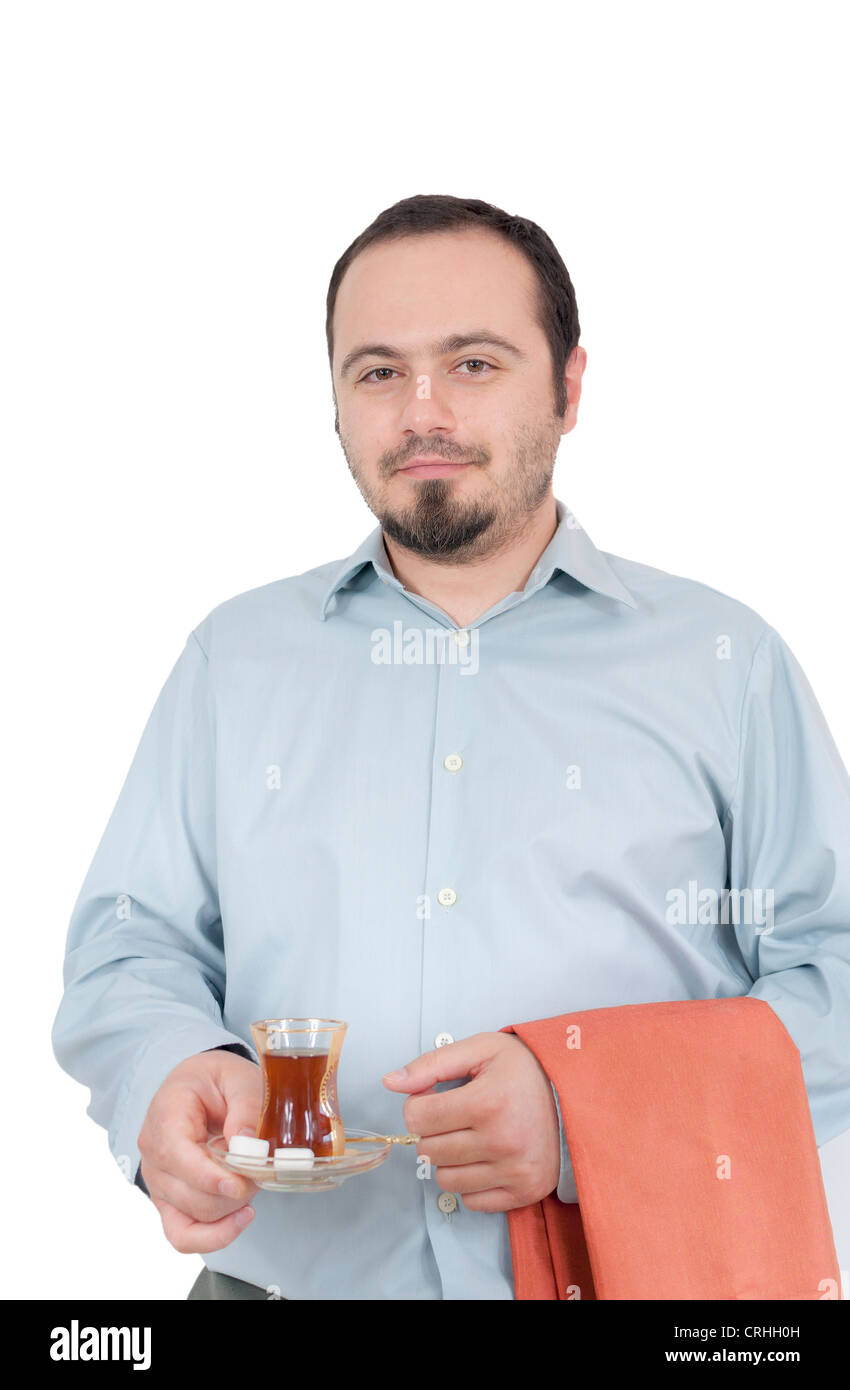 Young man serving traditional turkish chai in glass Stock Photo