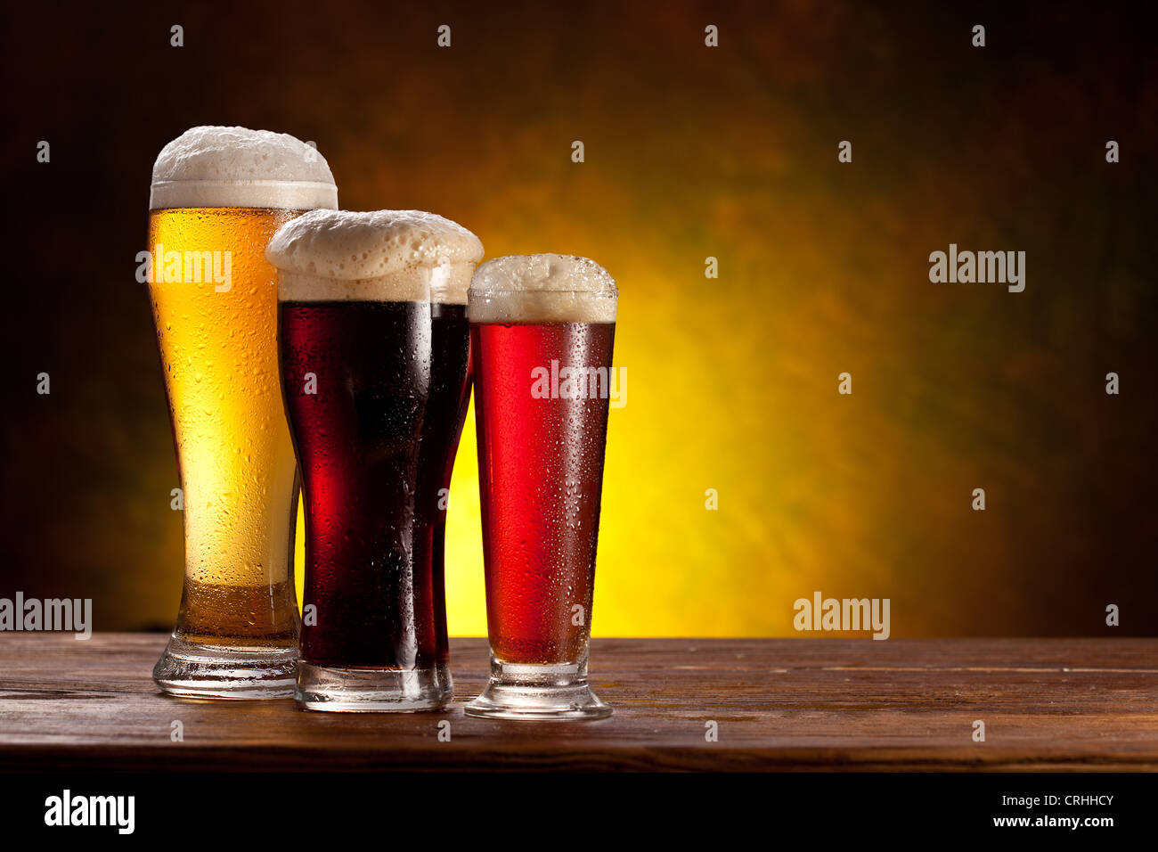Beer barrel with beer glasses on a wooden table. The dark background. Stock Photo