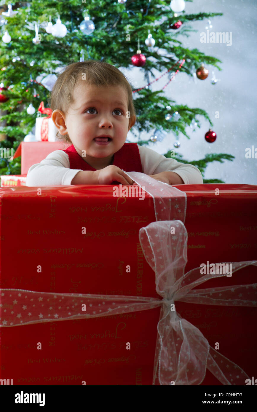 Baby girl opening large Christmas present Stock Photo Alamy