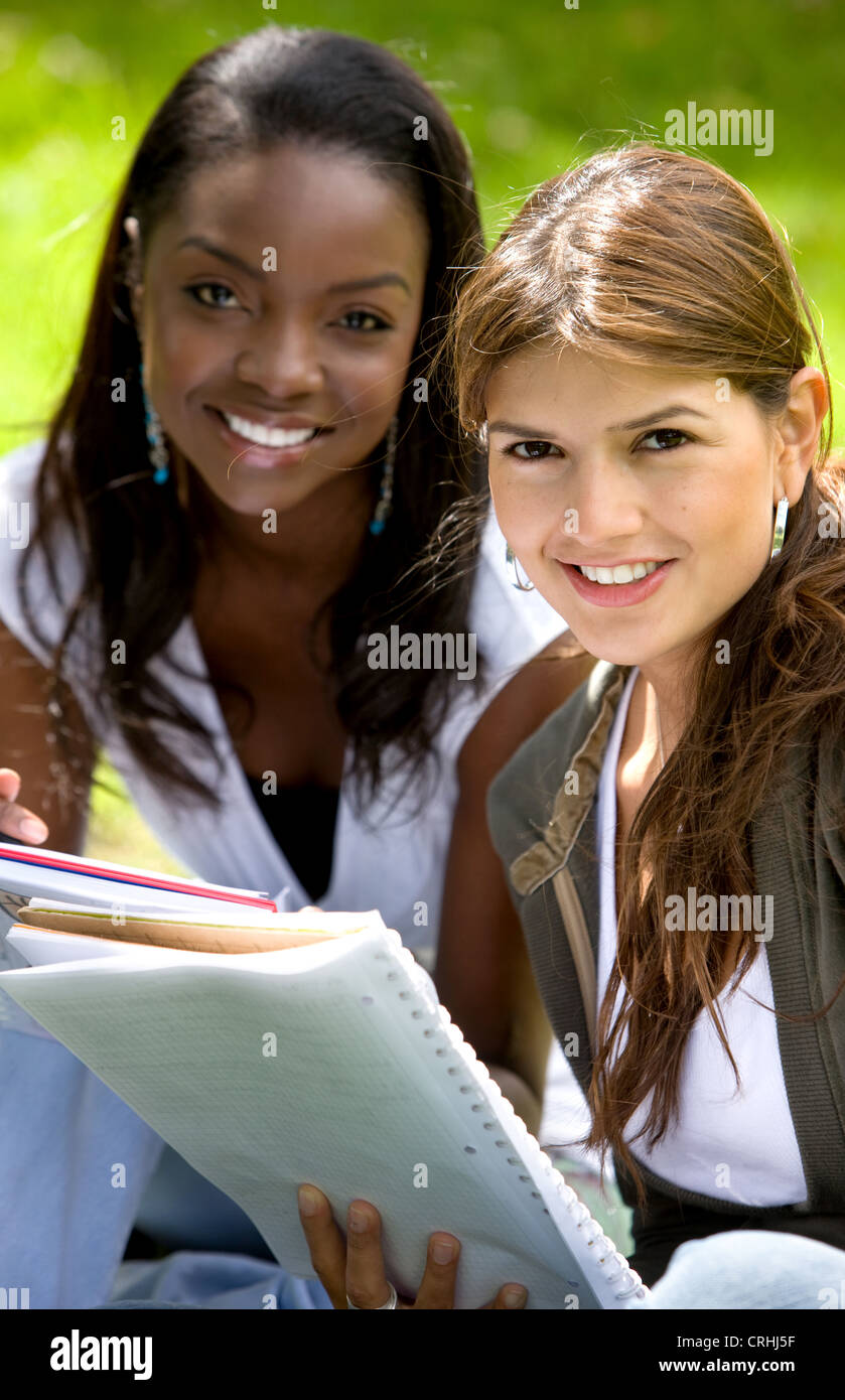 Two happy coeds with notebook hi-res stock photography and images - Alamy