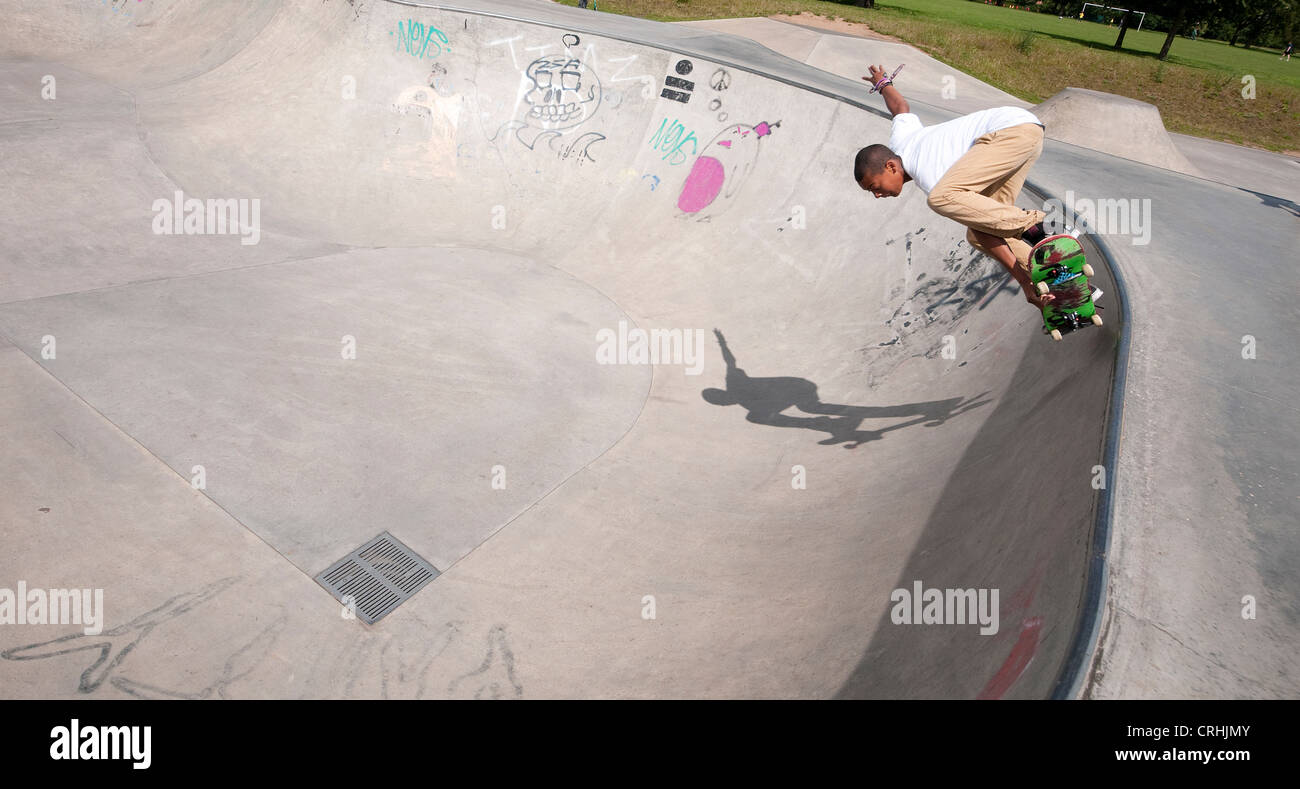 skateboarder in urban skate park bowl, eaton park, norwich, norfolk