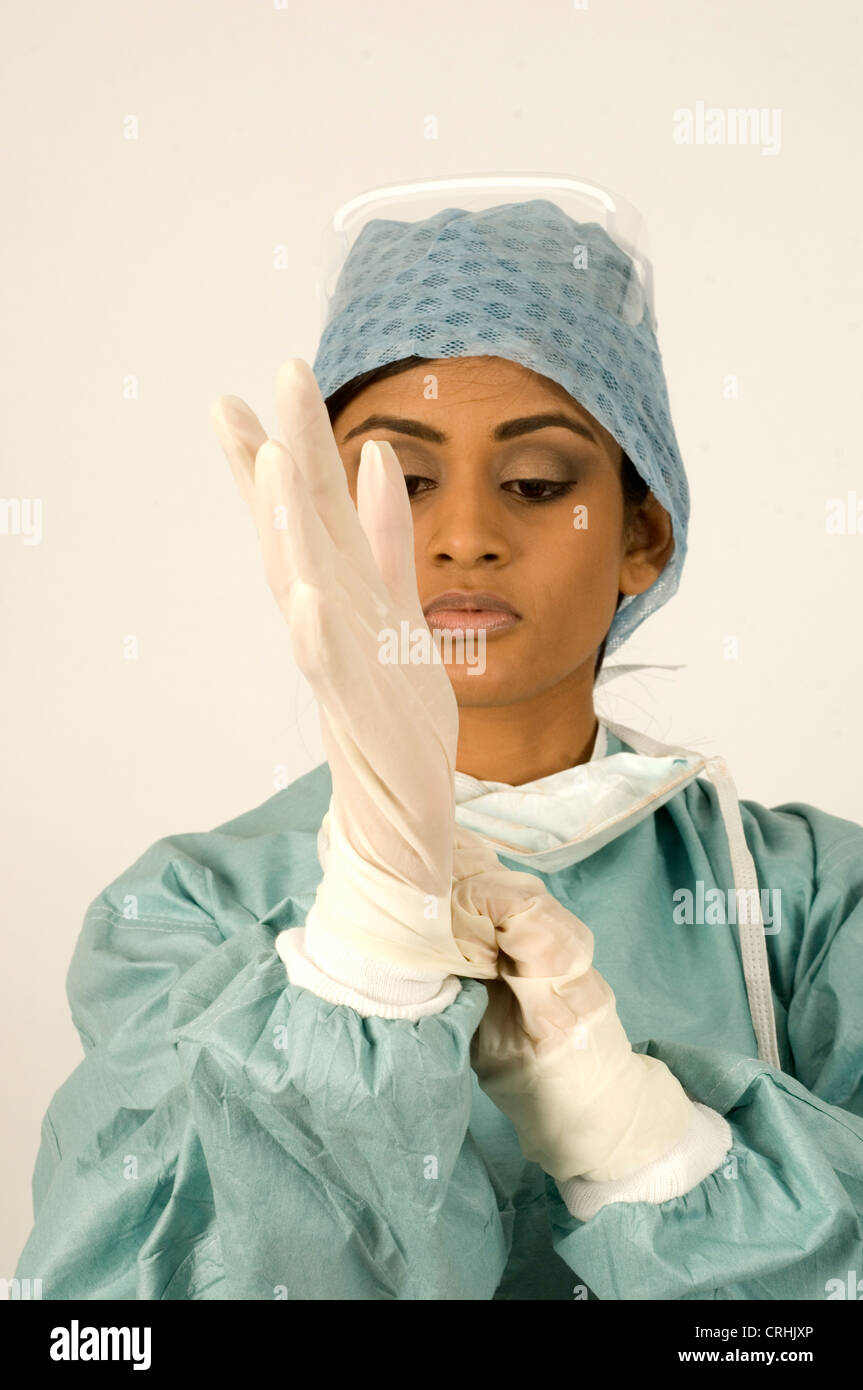 A surgeon putting on surgical gloves Stock Photo Alamy