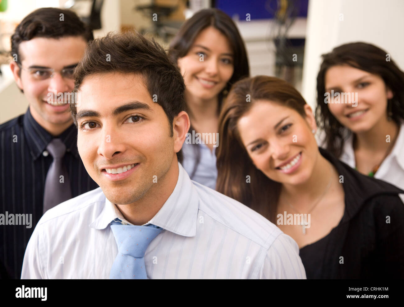 young businessman smiling leading a team in an office Stock Photo - Alamy