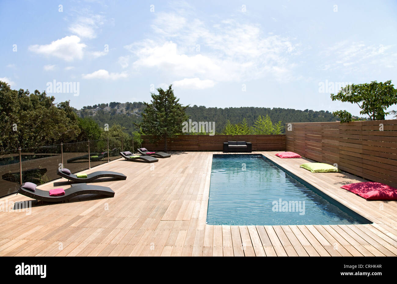 Lawn chairs and pool on modern deck Stock Photo Alamy