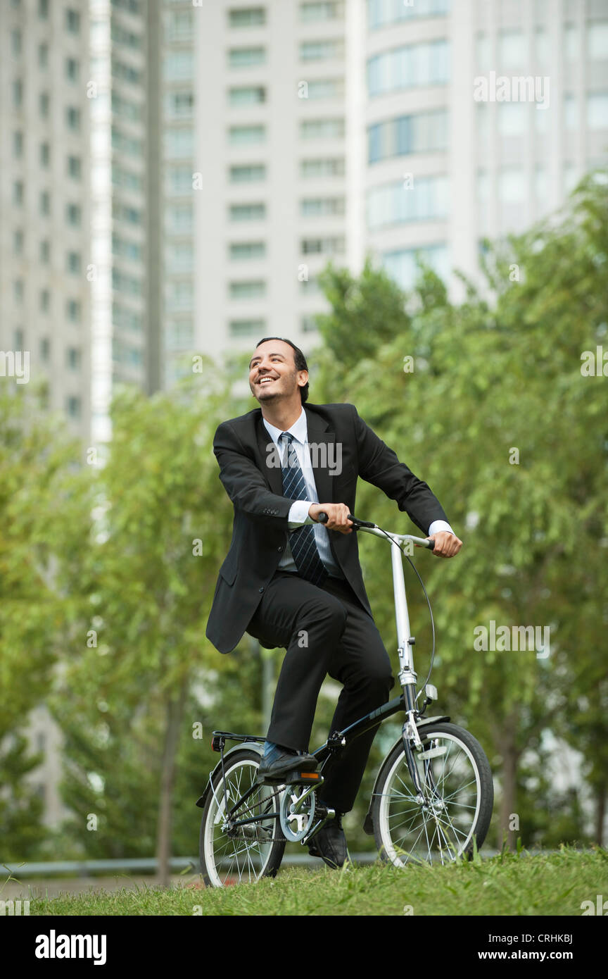 Businessman riding bicycle Stock Photo