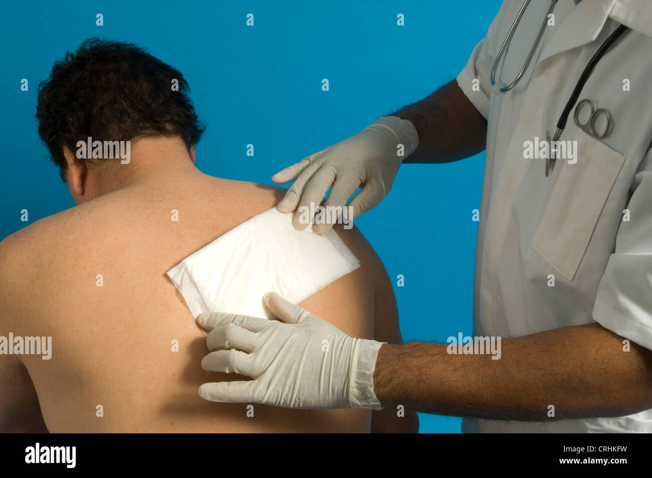 A nurse dresses a patient's back wound. Stock Photo