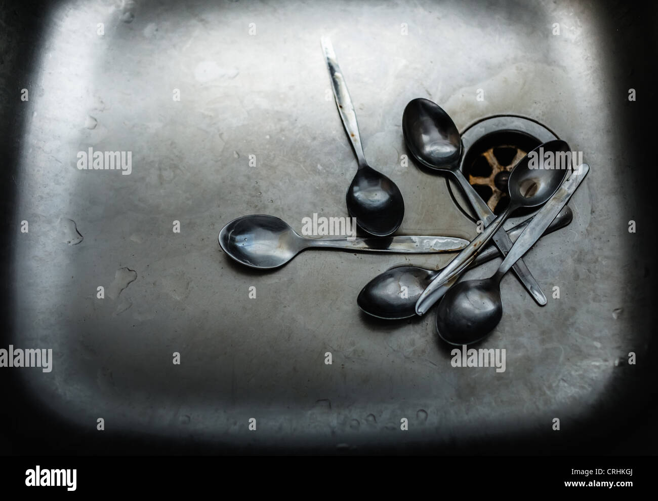 Pile of dirty spoons in sink Stock Photo Alamy