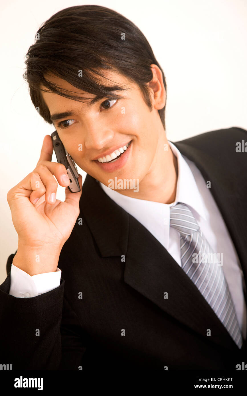 business man smiling and talking on a mobile phone Stock Photo