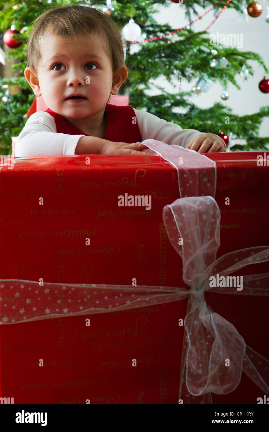 Baby girl opening large Christmas present Stock Photo Alamy