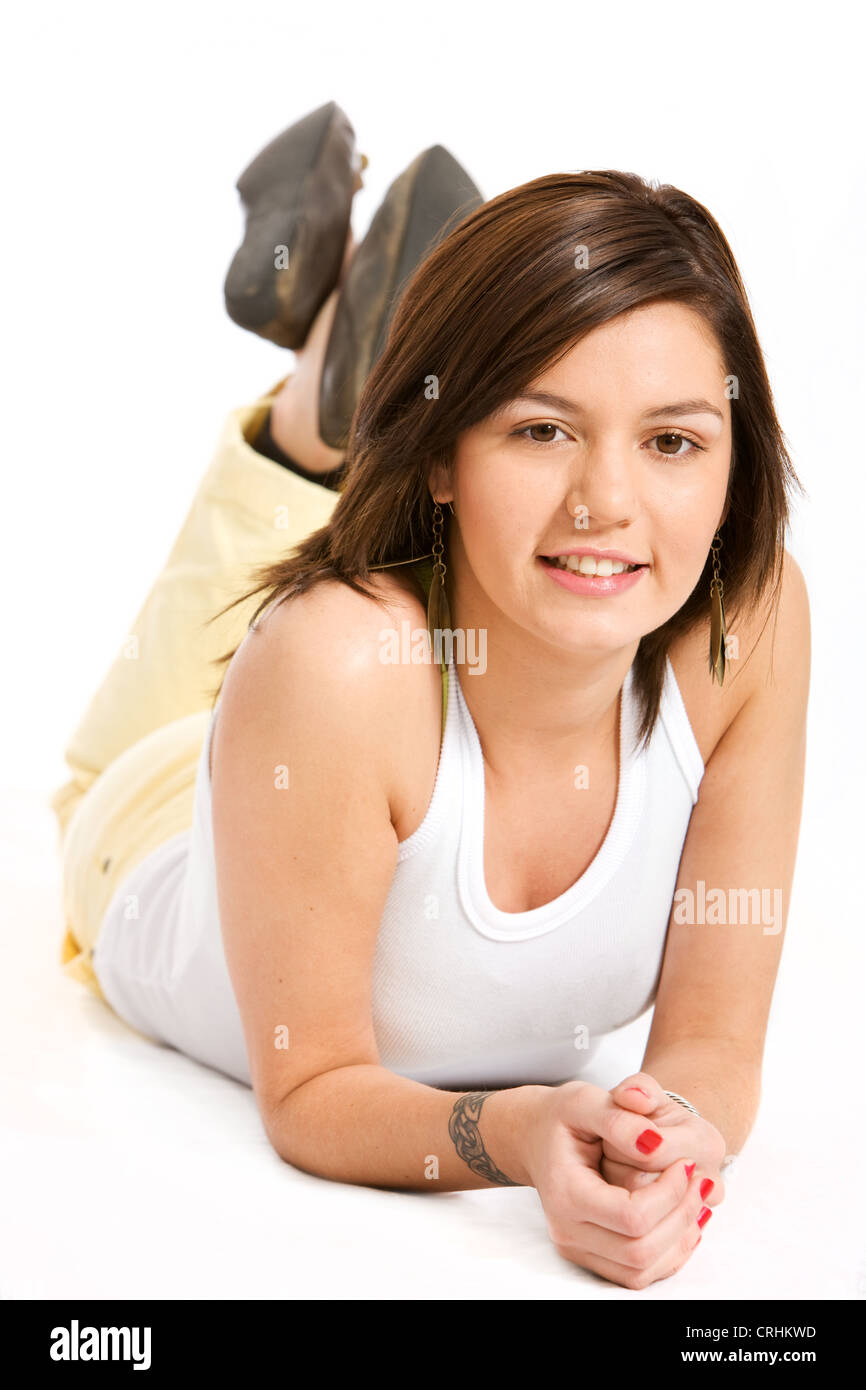 young cute woman with brown hair and brown eyes, lying on the floor Stock Photo