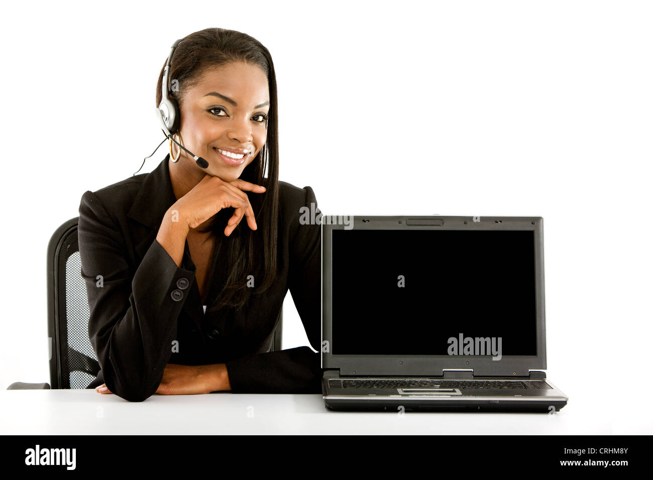 dark-skinned young woman with headset and laptop Stock Photo