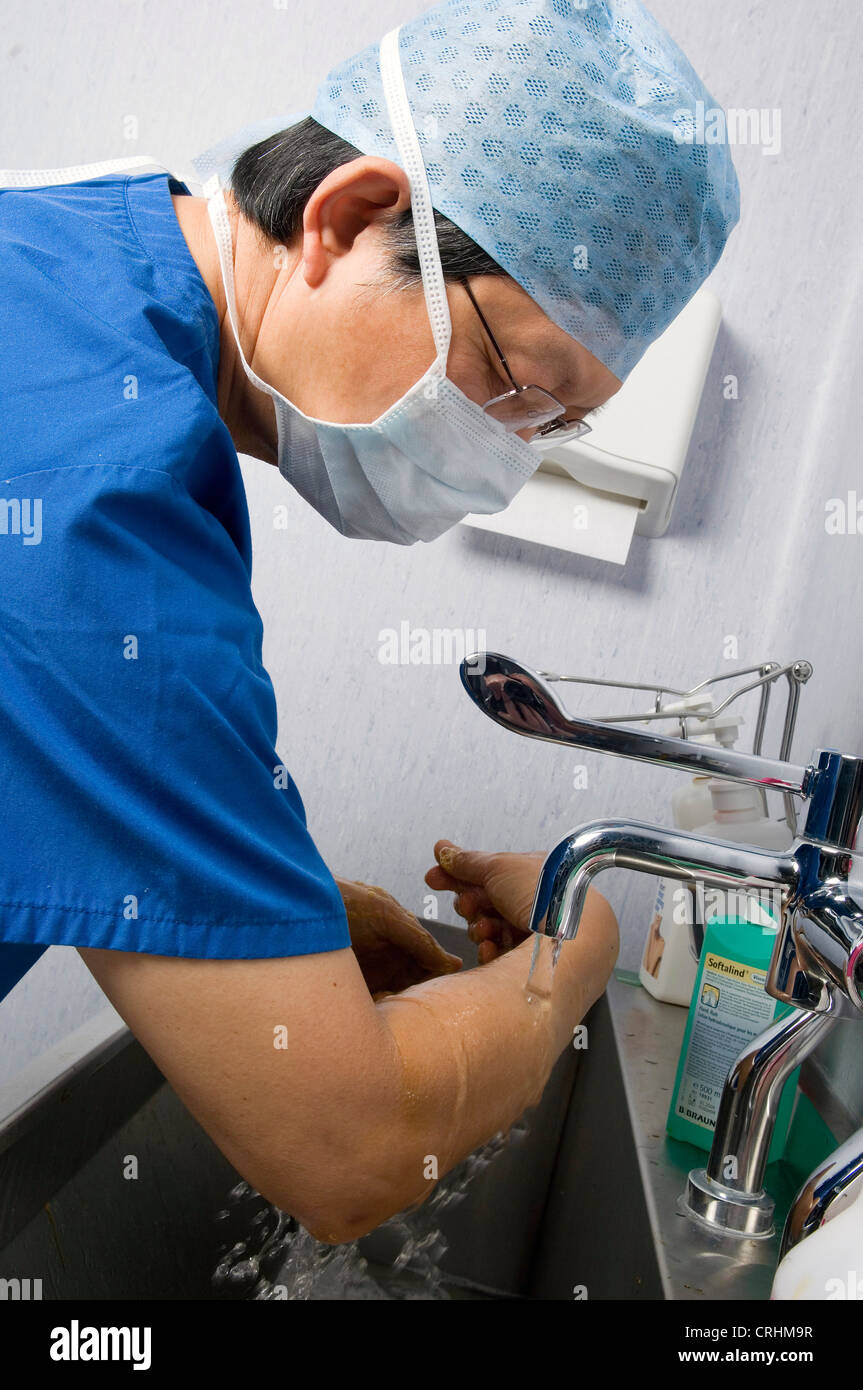 A doctor scrubs his hands as part of procedure before and after surgery