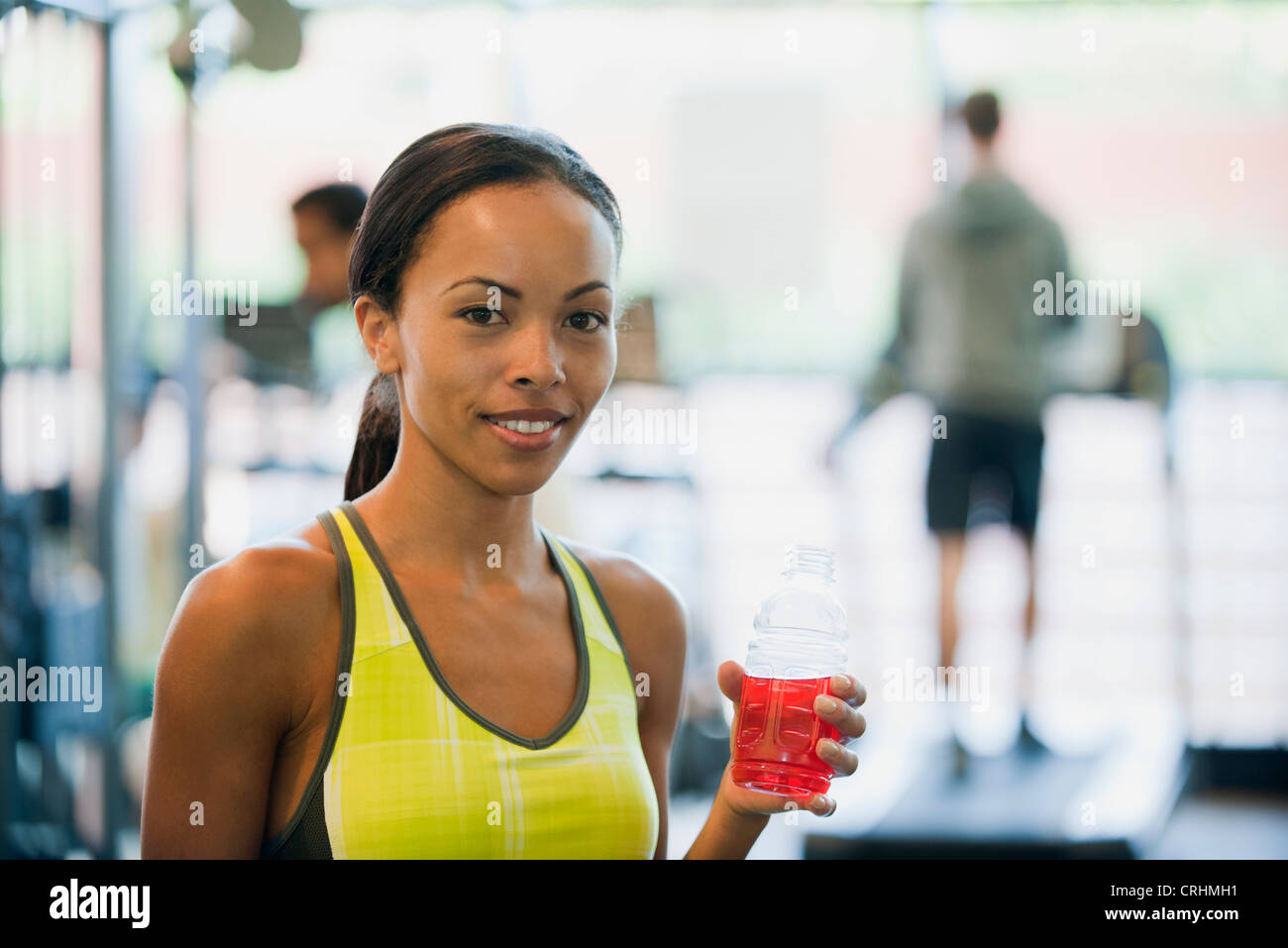 Young woman holding sports drink bottle Stock Photo
