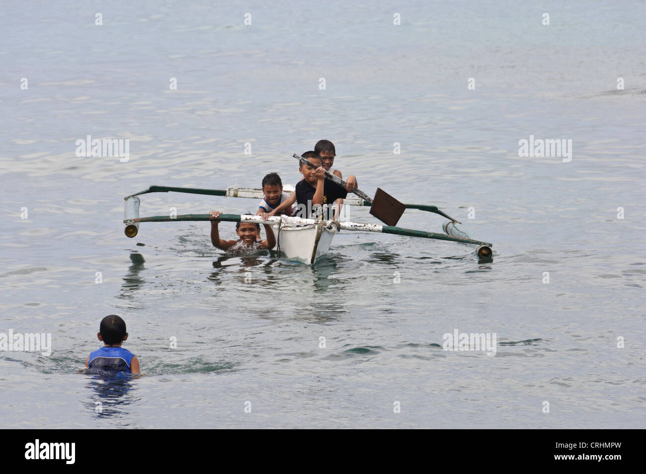 Boy paddling small boat hi-res stock photography and images - Alamy