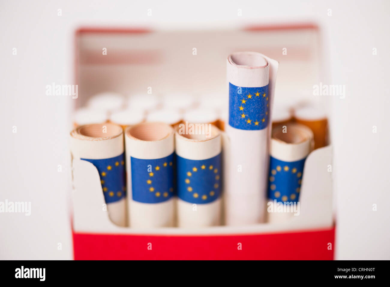 Cigarette pack containing rolled euros Stock Photo