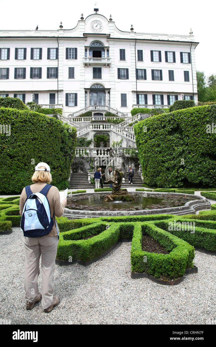 A woman looking at a guide leaflet at Villa Carlotta, Lake Como, Lombardy, Italian Lakes, Italy Stock Photo