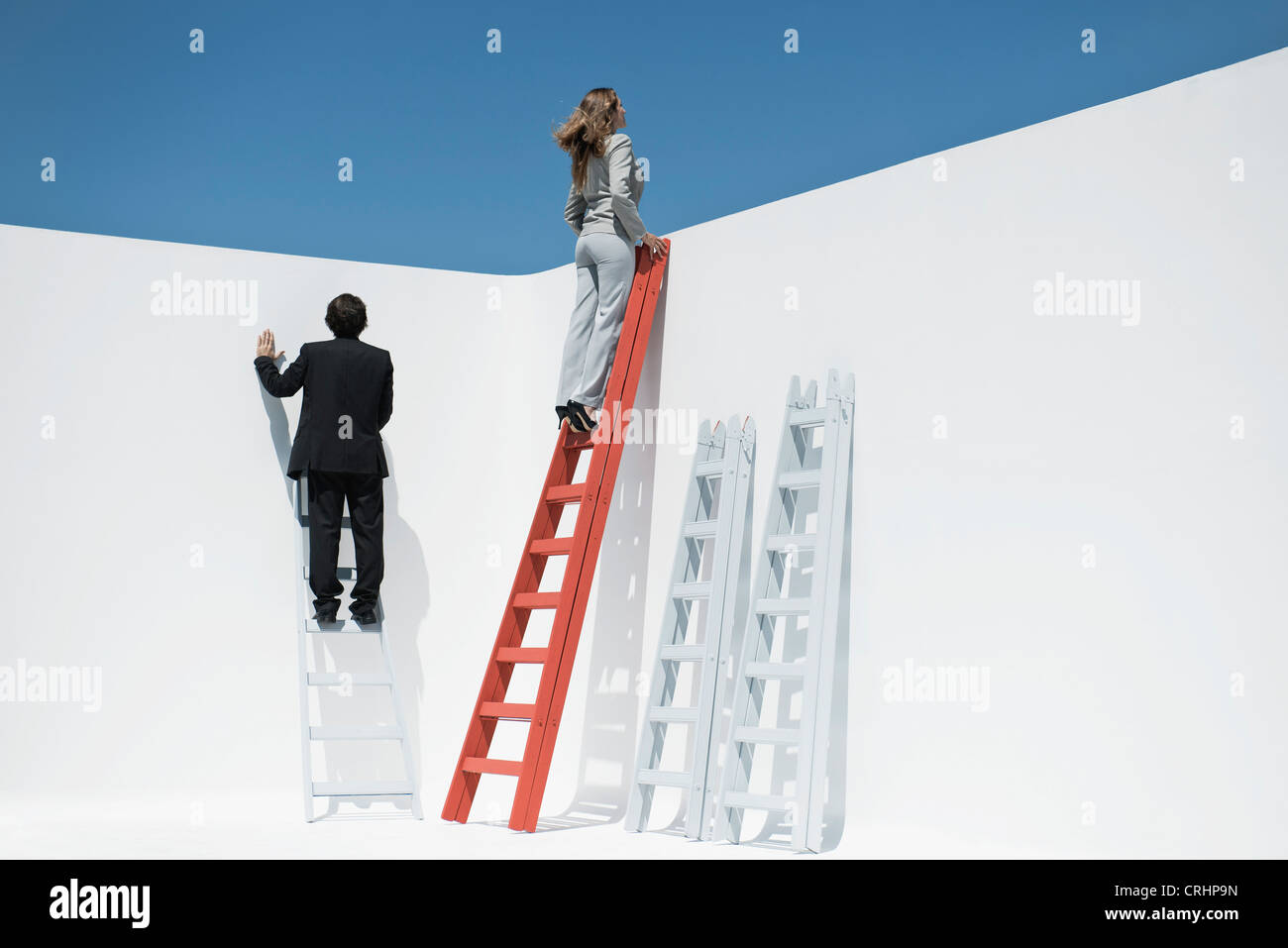 Businesswoman at top of ladder Stock Photo