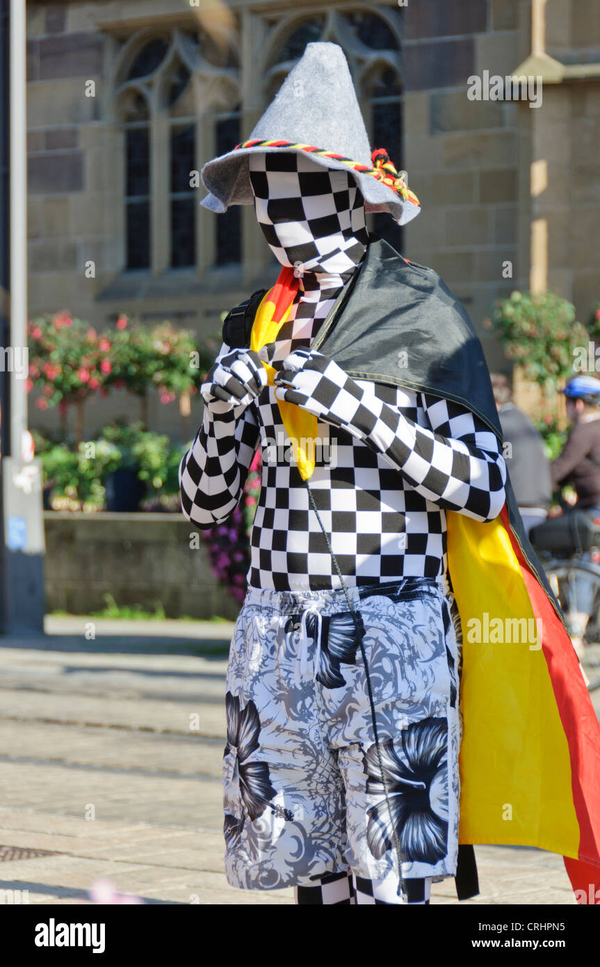 Male German soccer football fan in chess pattern Zentai Morphsuit and traditional Bavarian hat and German flag Heilbronn Germany Stock Photo