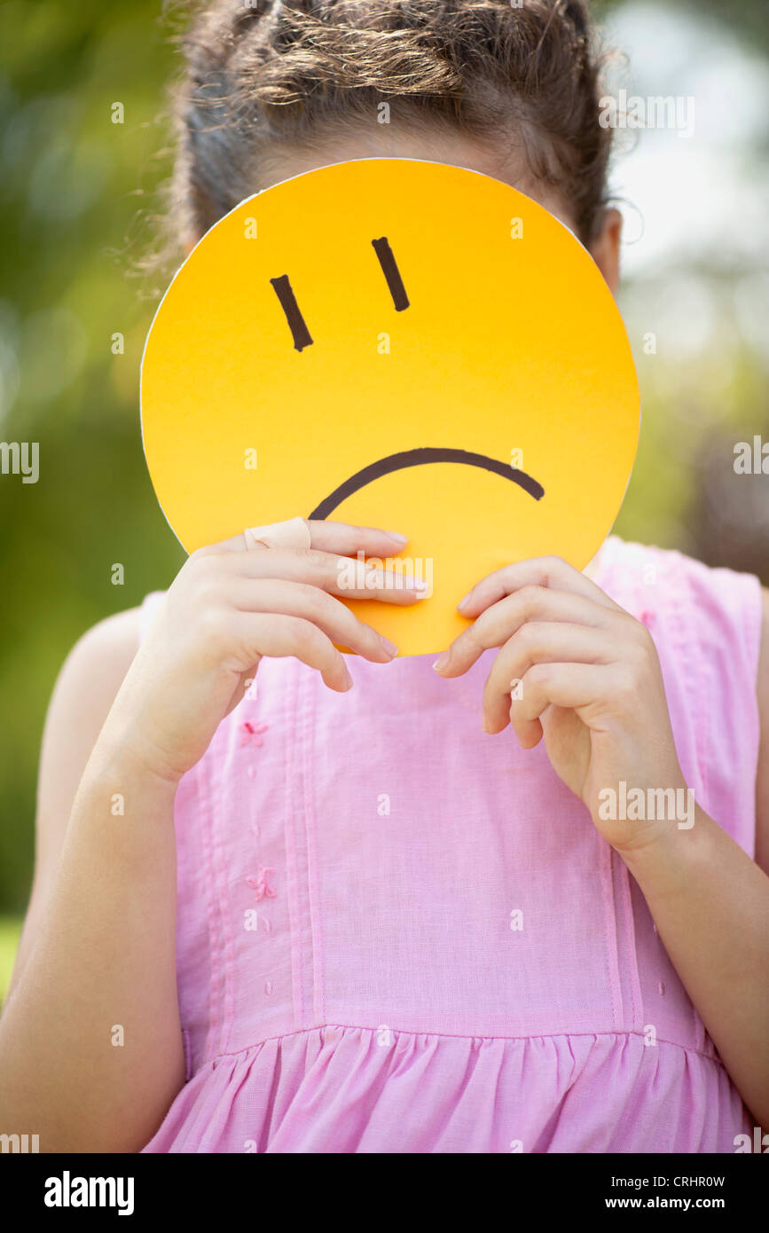 Girl with sad face mask Stock Photo