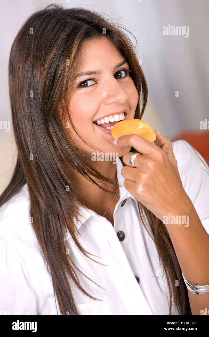 woman at home having breakfast and smiling Stock Photo