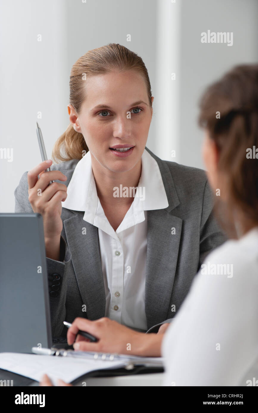 Businesswoman advising client Stock Photo - Alamy