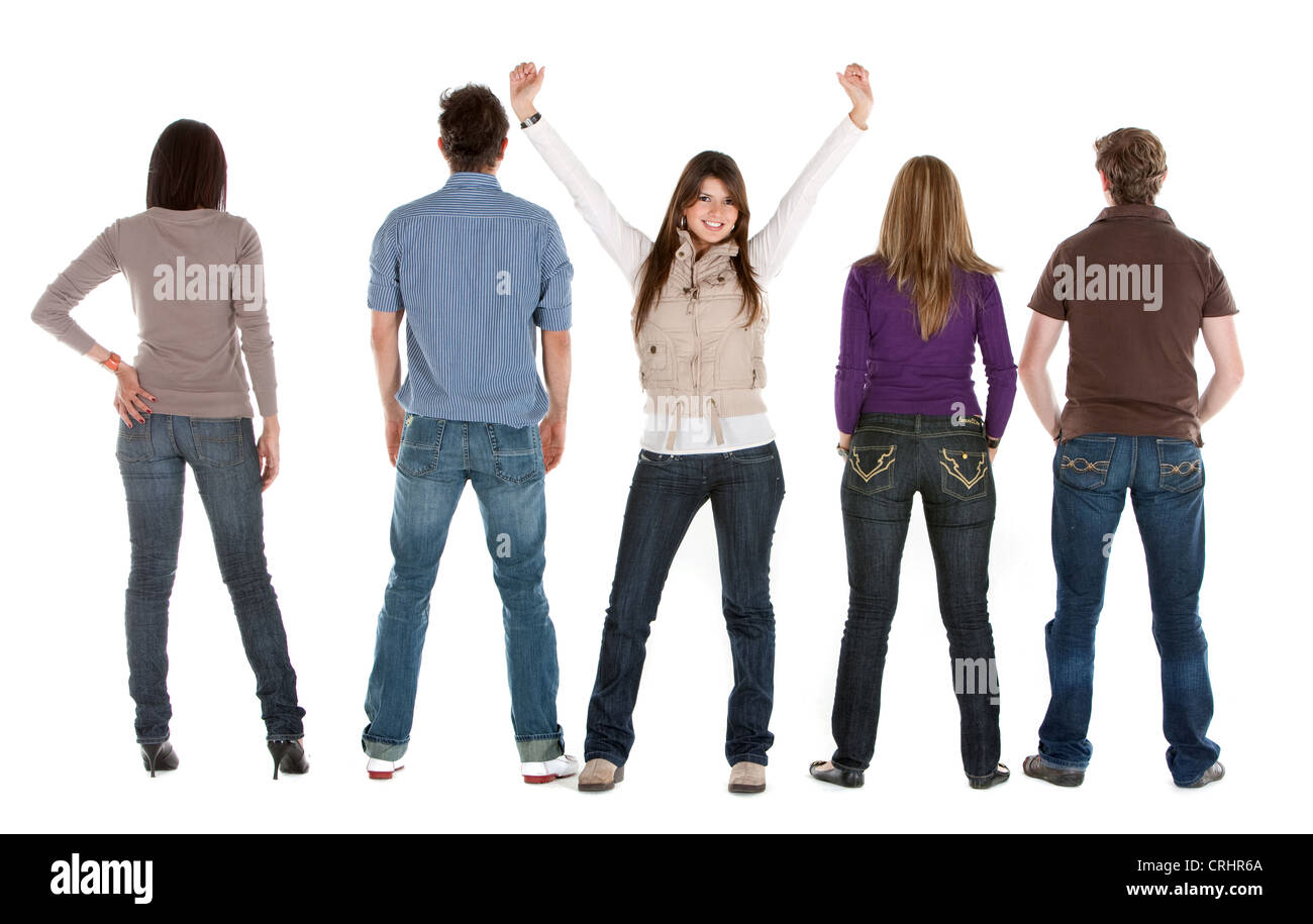 reir view of a group of young people with a girl facing the camera, with outstretched arms Stock Photo