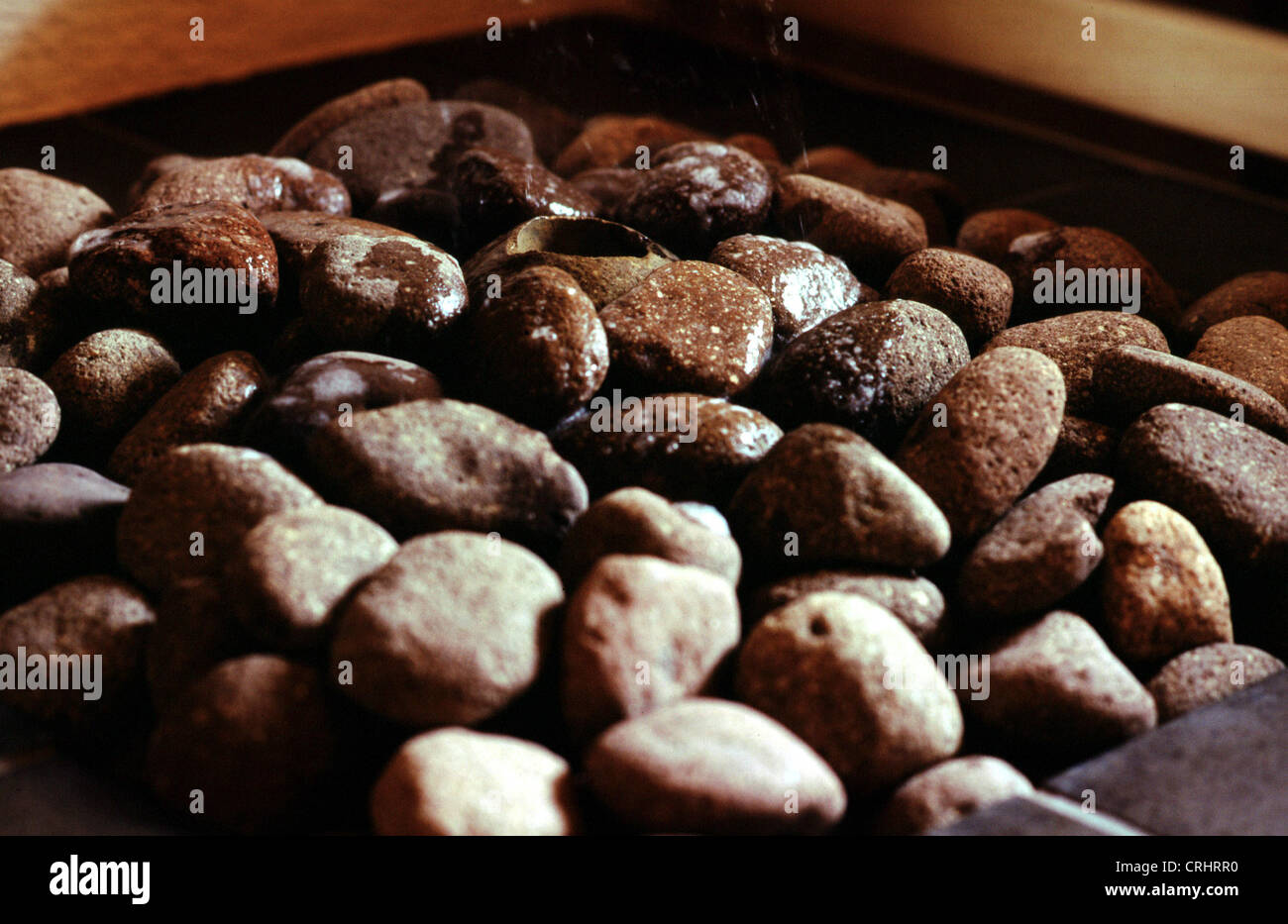 Pebbles for the steam infusion on a sauna stove Stock Photo