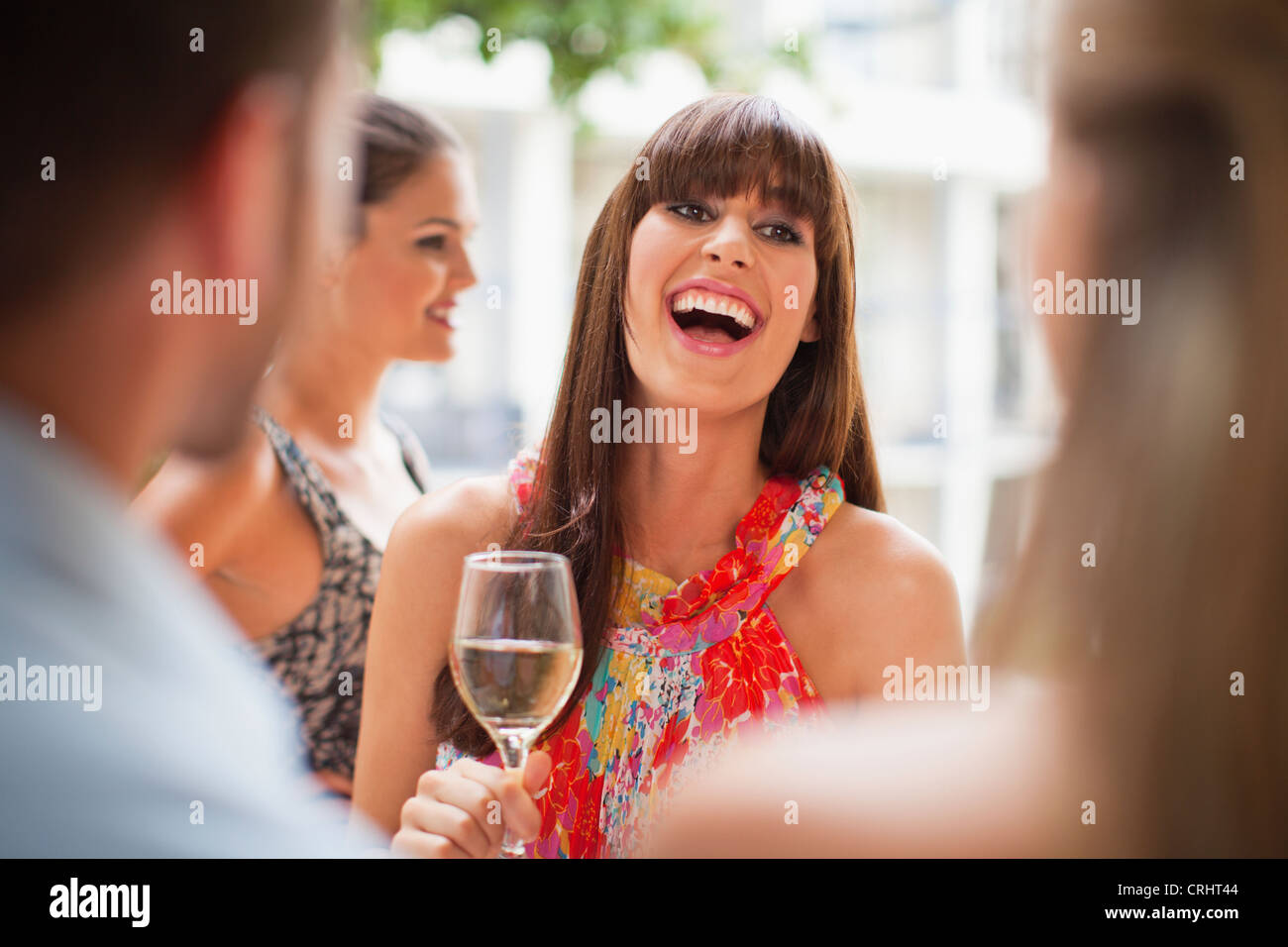 Woman talking in group at party Stock Photo