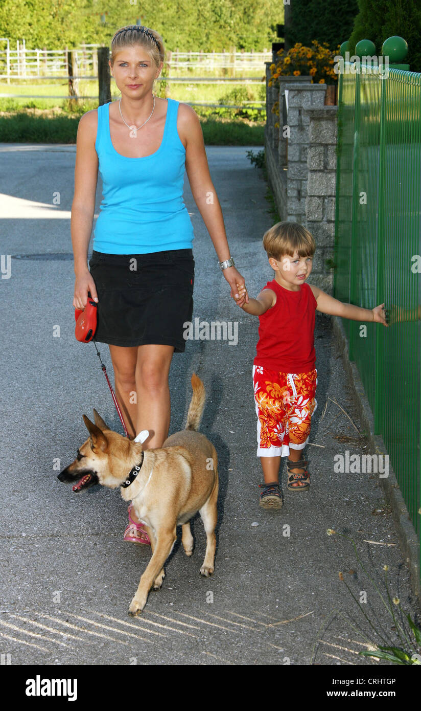 young mother walking with son and dog Stock Photo