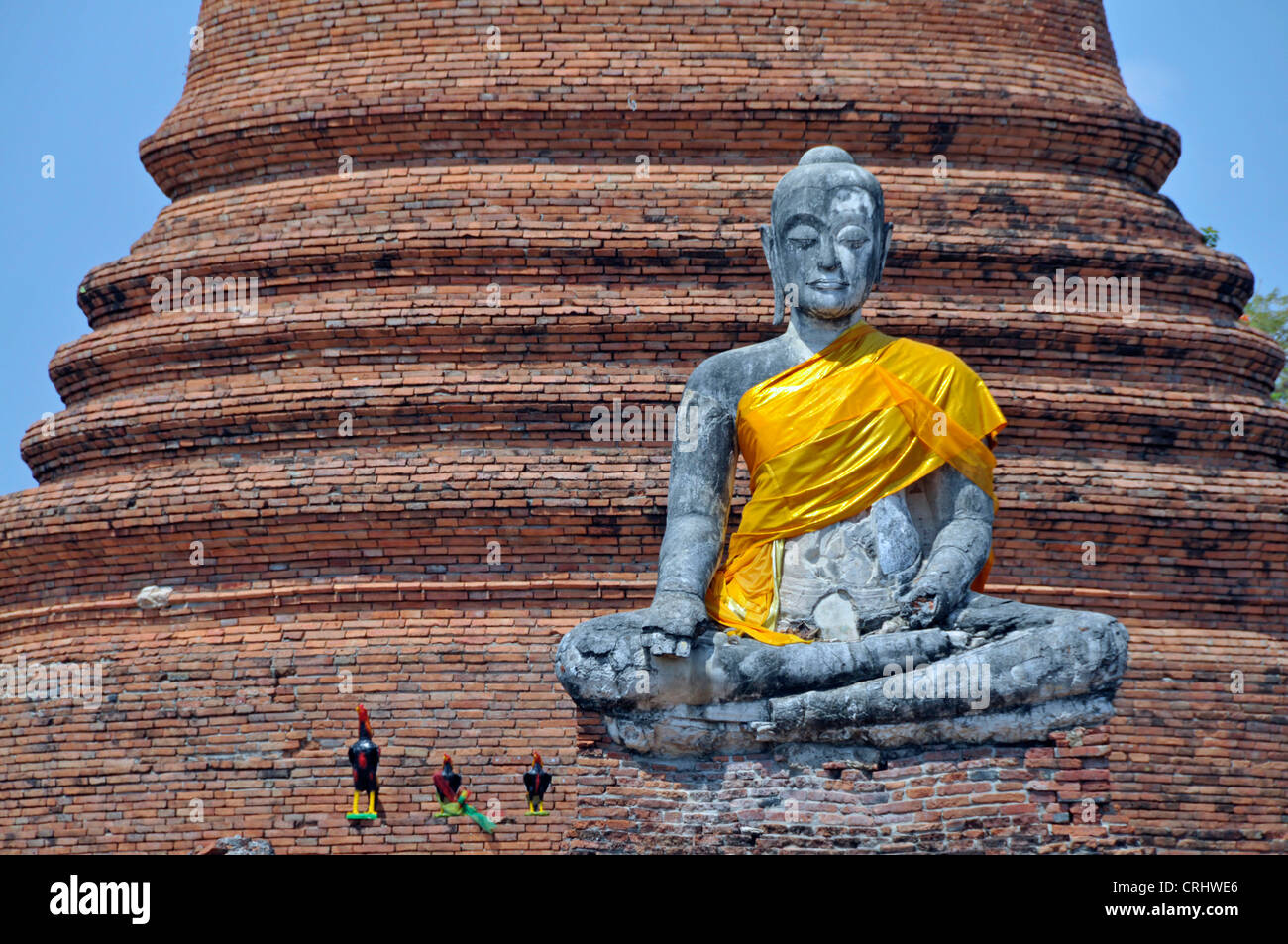 weathered Buddha statue with gesture of Bhumisparsa mudra in fron of the Chedi des Wat Worachetha Ram, Thailand, Ayutthaya Stock Photo