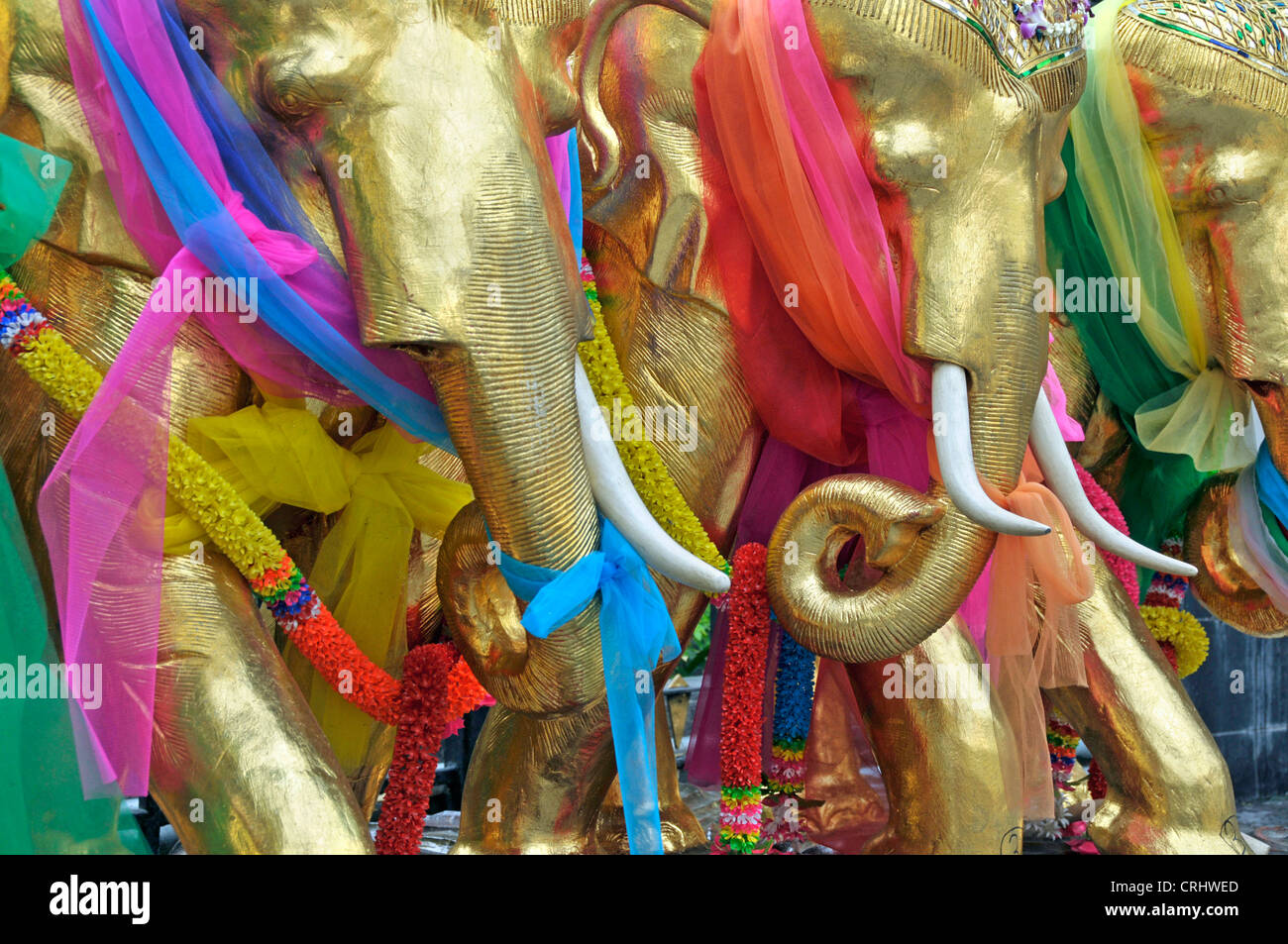 golden Teak elephants with lucky charm loops, Erewan shrine, Thailand, Bangkok Stock Photo