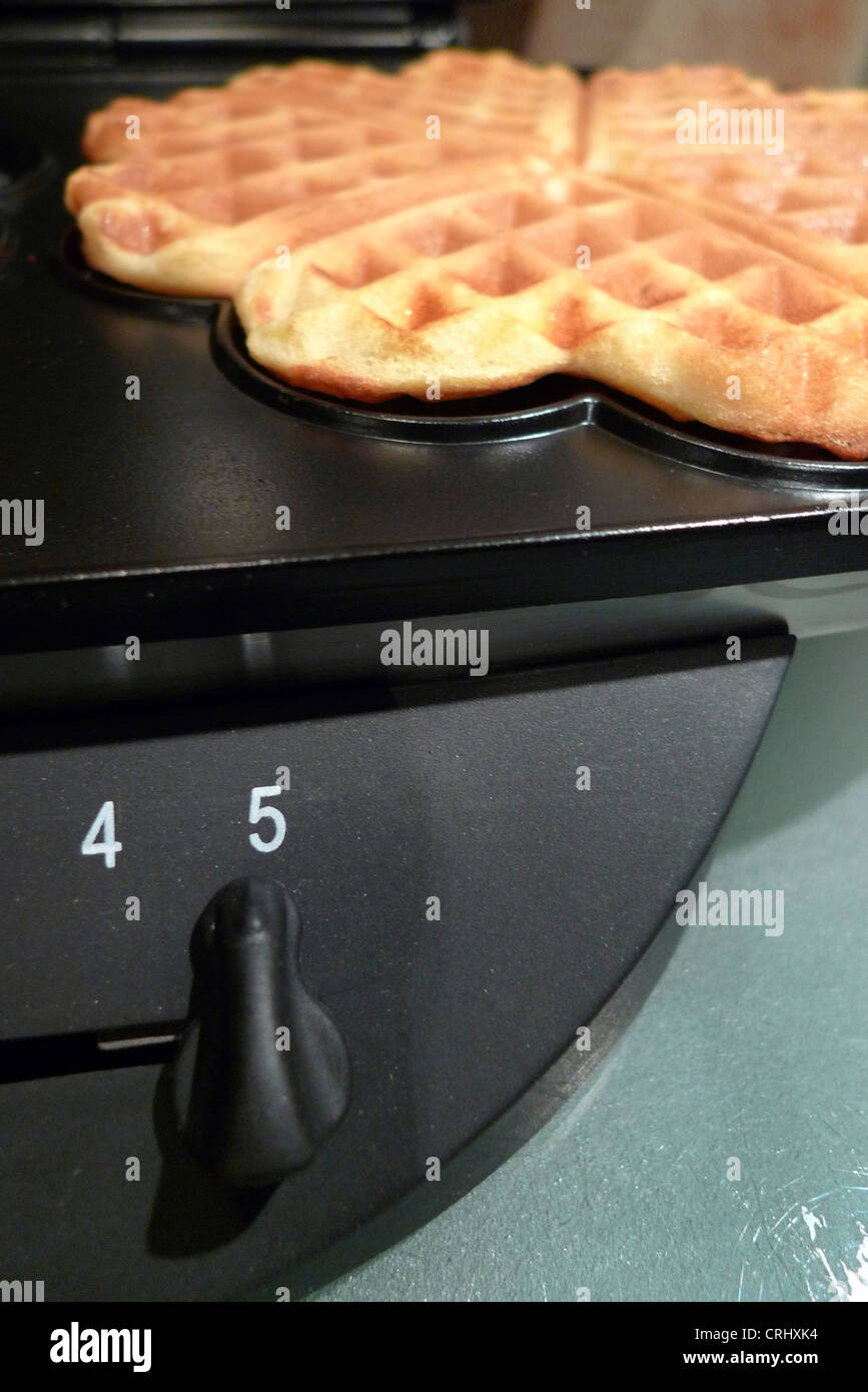 wafer in a waffle iron Stock Photo Alamy