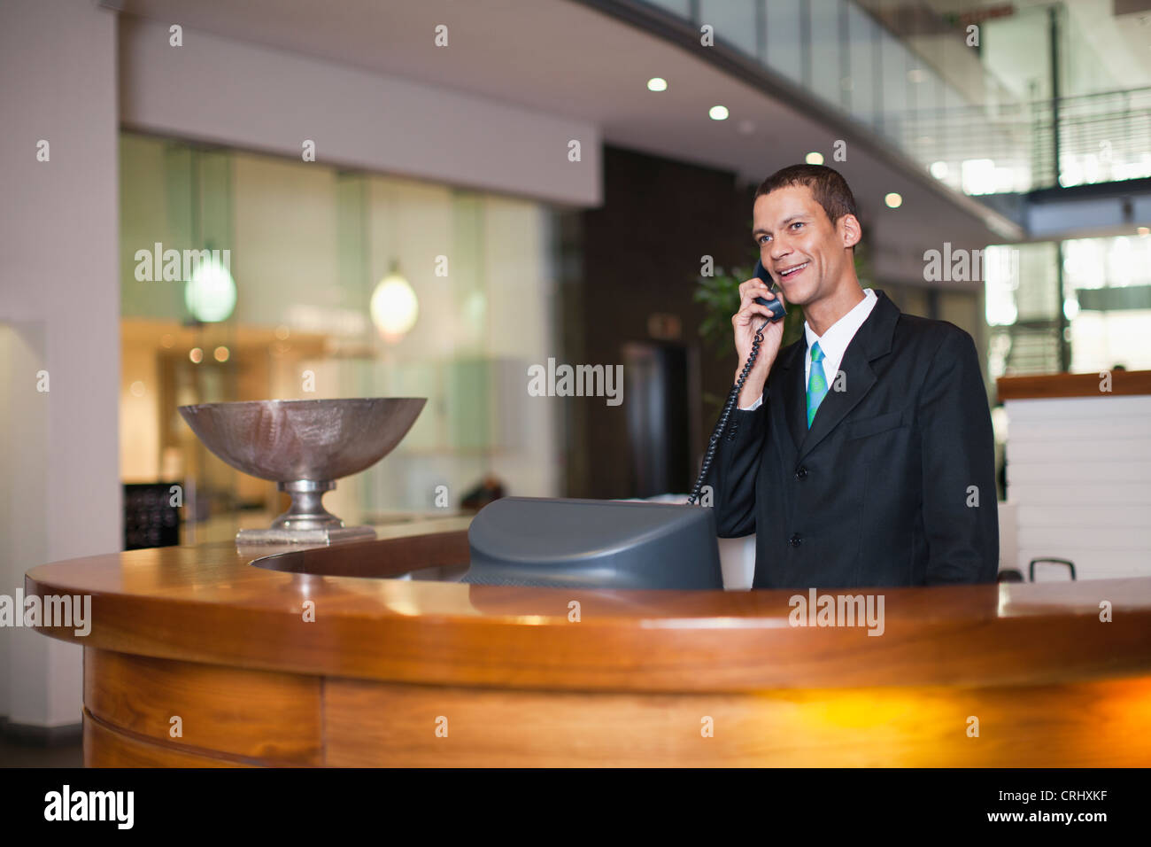 Hotel concierge talking on phone Stock Photo Alamy