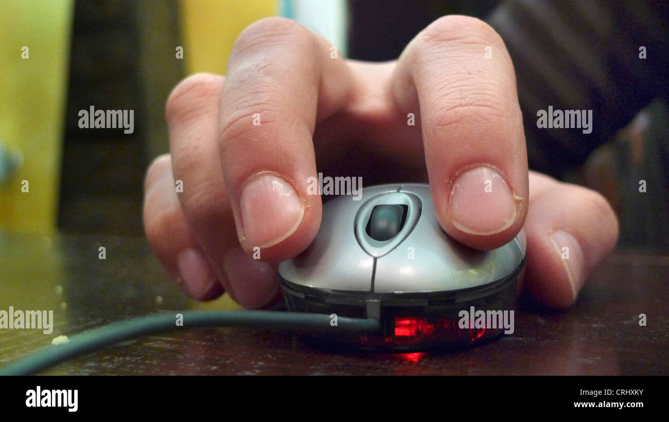 hand holding a PC mouse Stock Photo