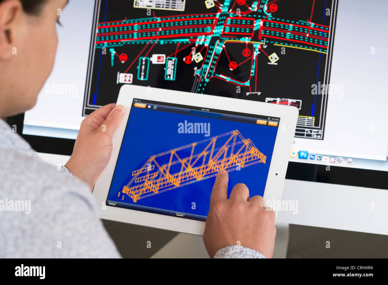 Engineer using iPad CAD Computer Aided Design application to model 3D design of new bridge Stock Photo