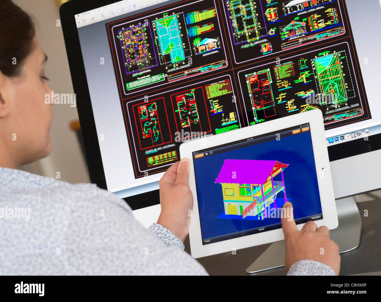 Architect using iPad CAD Computer Aided Design application to model 3D layout design of new house Stock Photo