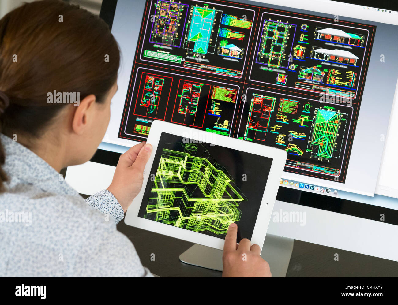 Architect using iPad CAD Computer Aided Design application to model 3D layout design of new house Stock Photo