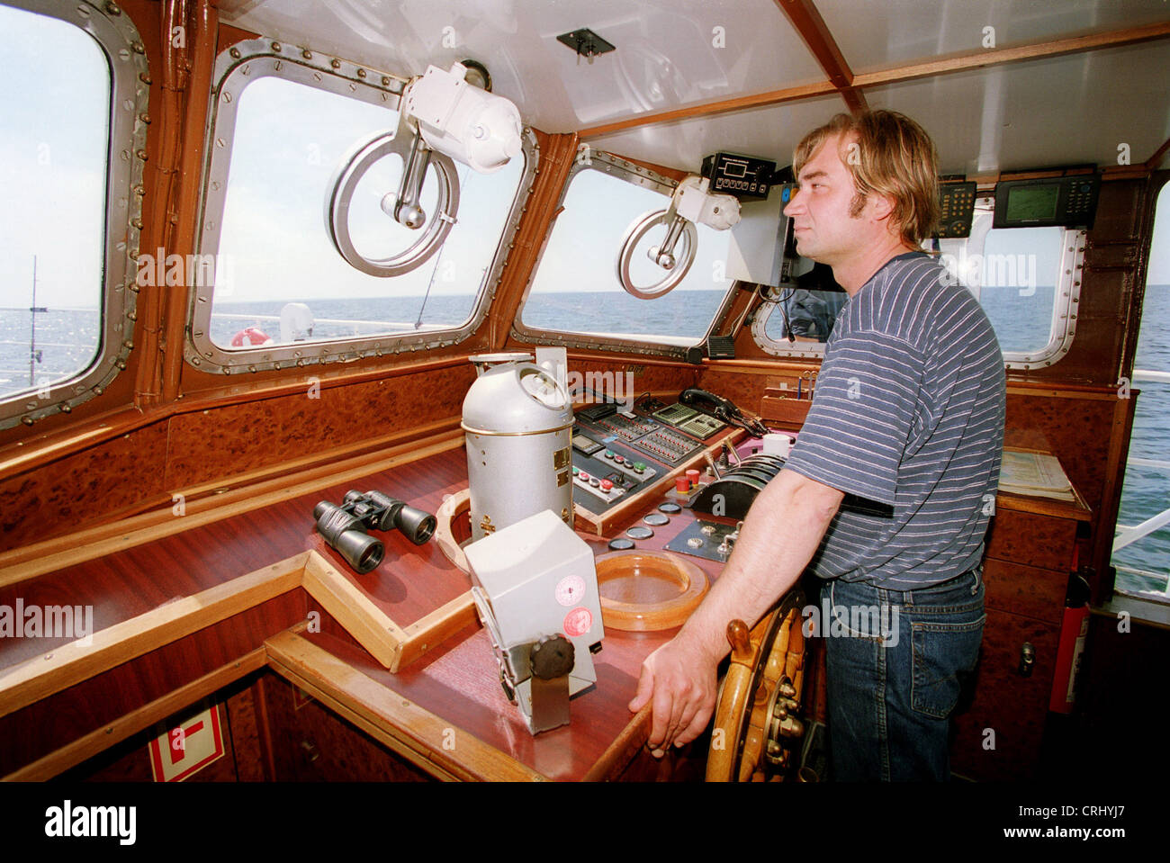 Captain on a cutter at the exit for fishing Stock Photo Alamy