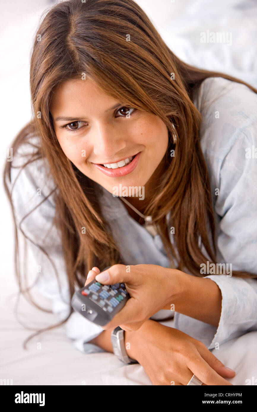 Woman with a remote control in her hands Stock Photo