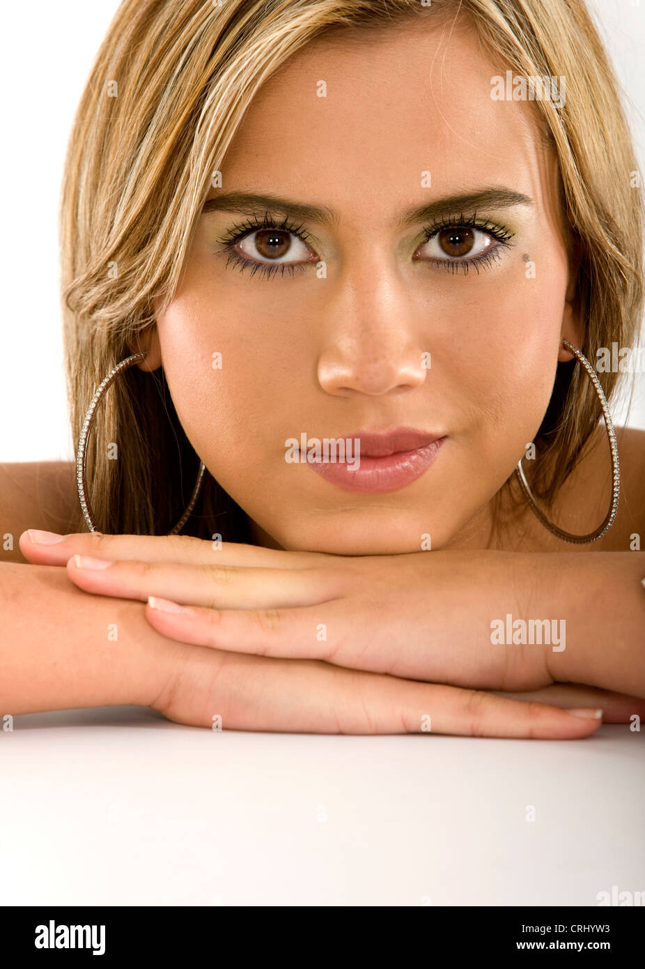 Beautiful woman smiling with head on her hands Stock Photo