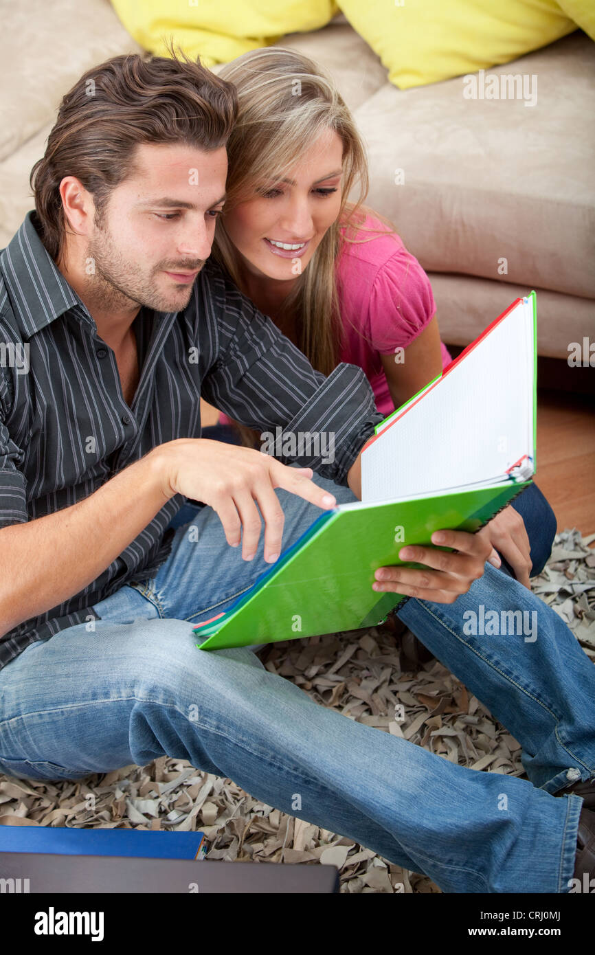 Couple of students studying in the living room Stock Photo