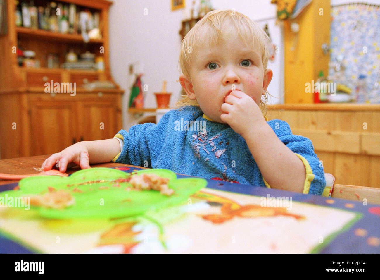 Toddler eating at the table Stock Photo Alamy