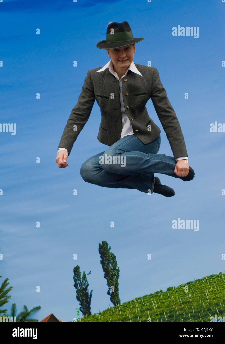 jumping Styrian person on trampoline, Austria, Styria Stock Photo