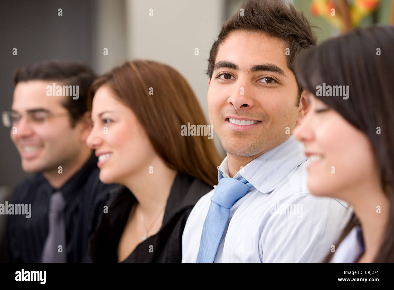 four smiling well-goomed young people, business man smiling ito the camera Stock Photo