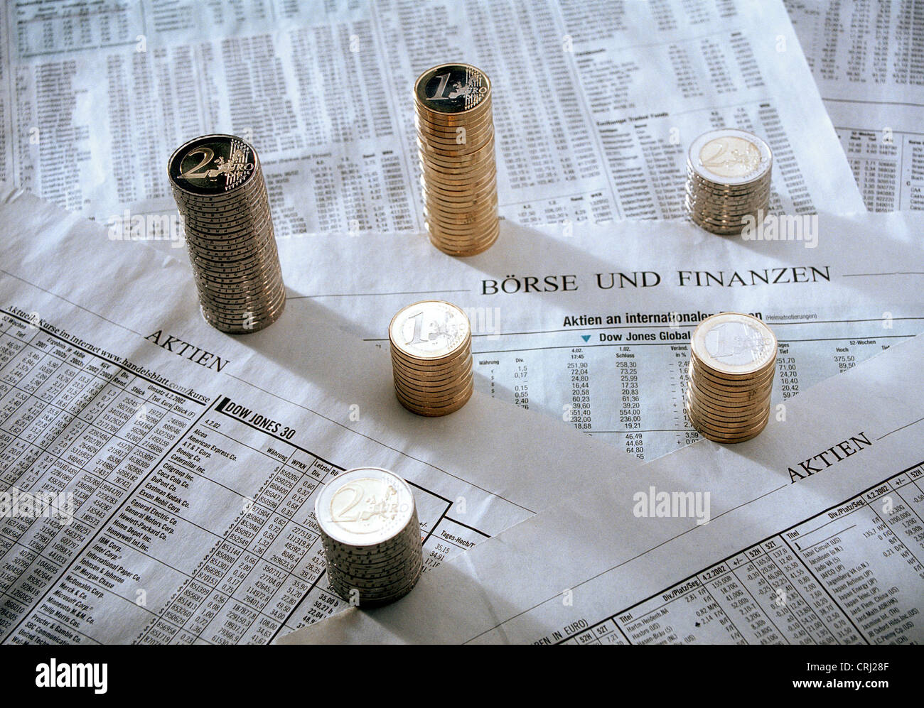 Stack of Euromuenzen on a newspaper page with stock market developments Stock Photo
