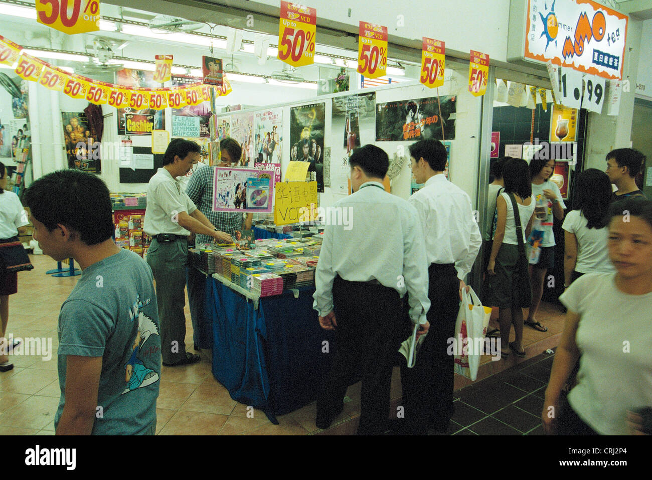 Customers at the counters with music CDs and video cassettes in Singapore Stock Photo