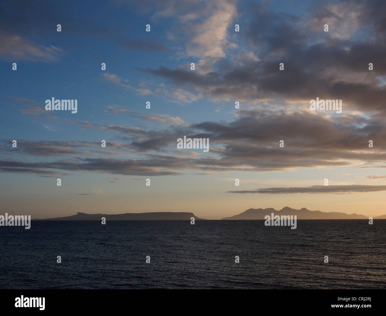 Sunset over Rum and Eigg from Morar Scotland Stock Photo - Alamy